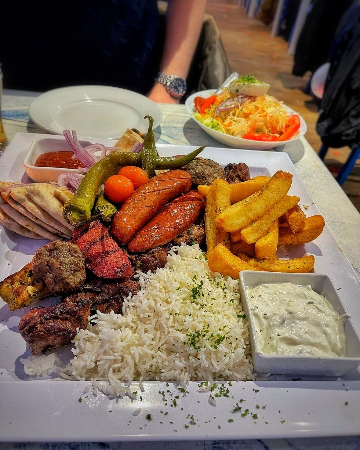 A table at Zorba The Greek filled with Greek dishes for a celebration