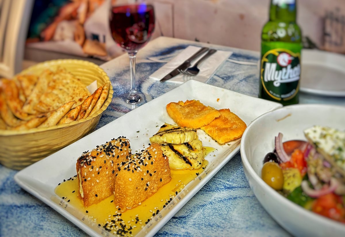 Round two of Zorba's meze — grilled cheese with bread, salad and a cold drink on the table